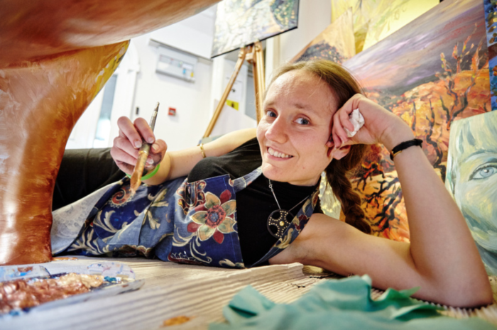 Lois Cordelia painting an art trail sculpture.